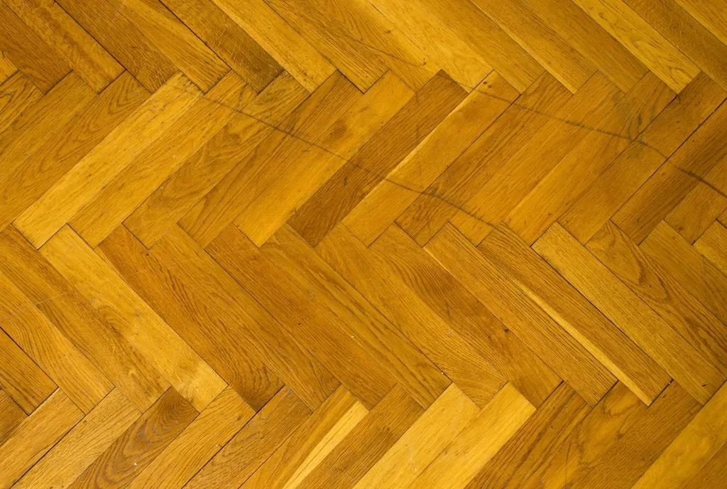 Golden herringbone parquet floor pattern